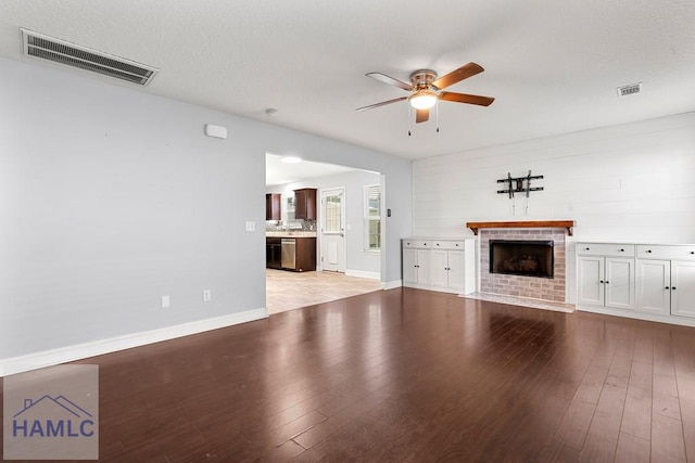 42 Kinlock Ct, Midway, GA 31320 - unfurnished living room featuring ceiling fan, light wood-style floors, and a brick fireplace