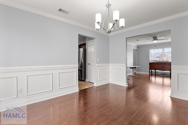 42 Kinlock Ct, Midway, GA 31320 - spare room with a chandelier, wood finished floors, crown molding, a decorative wall, and a wainscoted wall