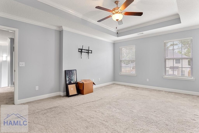 42 Kinlock Ct, Midway, GA 31320 - empty room with crown molding, plenty of natural light, carpet floors, a ceiling fan, and a raised ceiling