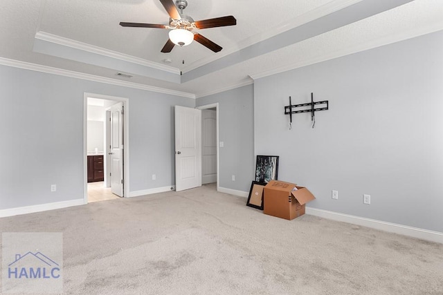 42 Kinlock Ct, Midway, GA 31320 - unfurnished bedroom with a raised ceiling, crown molding, carpet floors, a ceiling fan, and connected bathroom