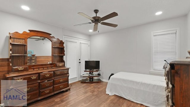 bedroom with ceiling fan and hardwood / wood-style floors