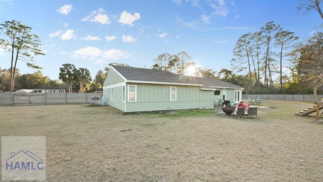 back of property featuring a yard