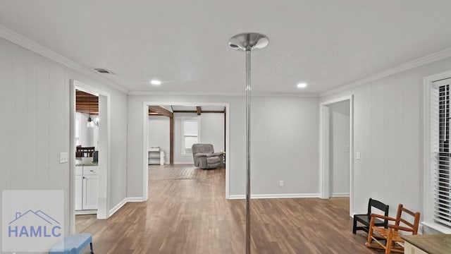 interior space featuring crown molding and wood-type flooring