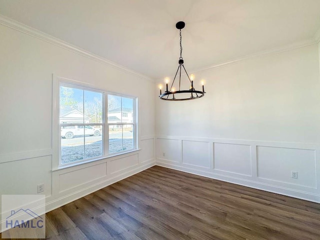 unfurnished dining area with a notable chandelier, dark hardwood / wood-style floors, and crown molding