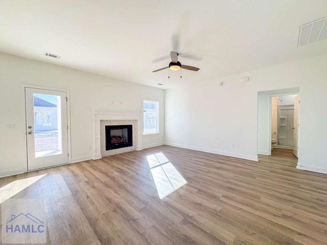 unfurnished living room featuring ceiling fan and light hardwood / wood-style flooring