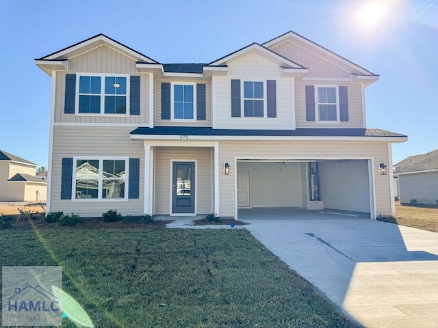 view of front of property featuring a front yard and a garage