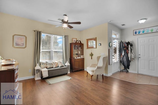 foyer entrance featuring wood finished floors, baseboards, and ceiling fan