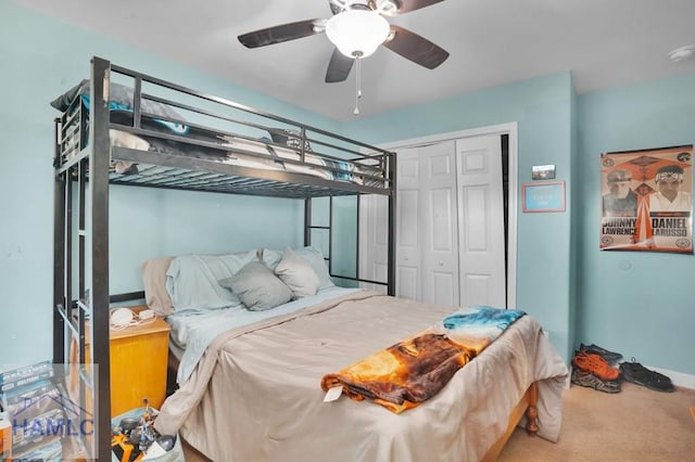 carpeted bedroom with a closet and ceiling fan