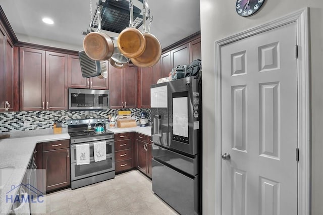 kitchen with tasteful backsplash and appliances with stainless steel finishes