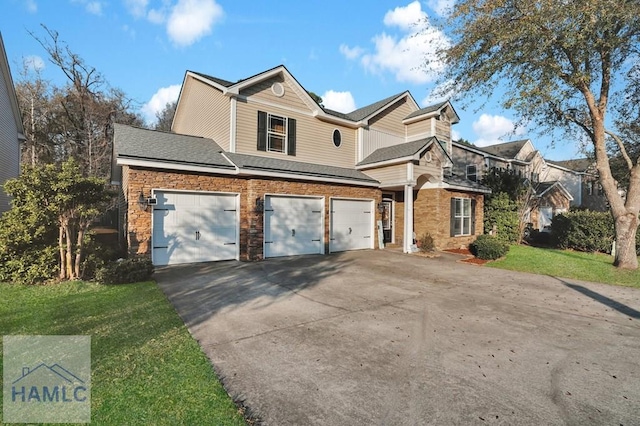 view of front of property featuring concrete driveway, an attached garage, a front lawn, and a shingled roof