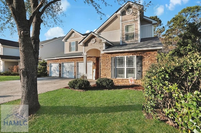 view of front of home with a garage, driveway, and a front lawn