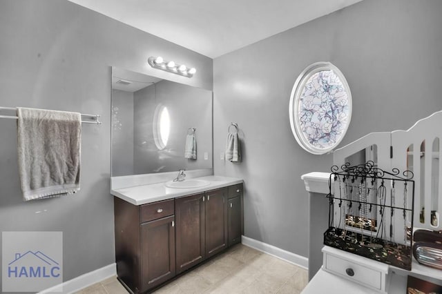 bathroom featuring baseboards and vanity