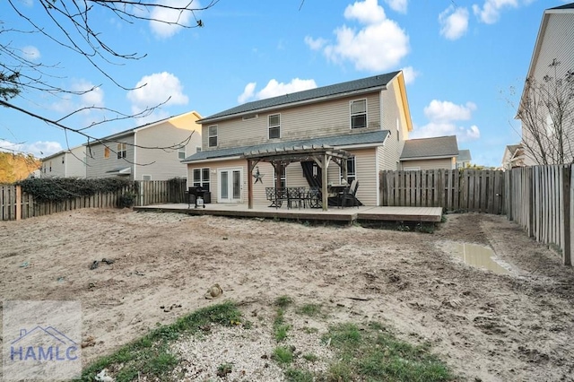 rear view of property featuring a deck, a fenced backyard, and a pergola