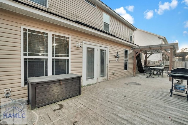 deck featuring a grill, a pergola, and outdoor dining area