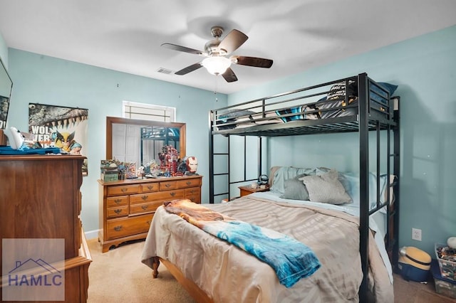 carpeted bedroom with visible vents and a ceiling fan