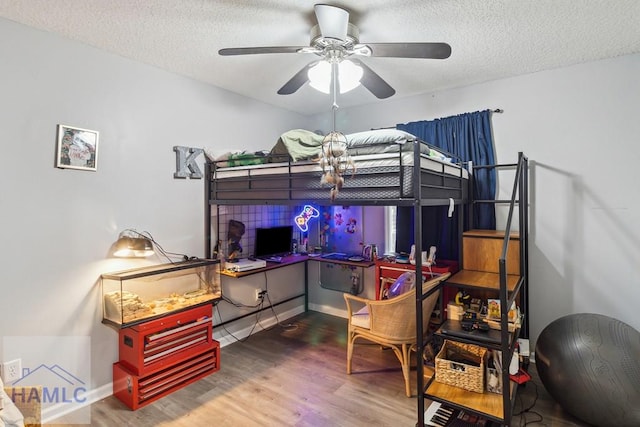 bedroom featuring a textured ceiling, hardwood / wood-style flooring, and ceiling fan