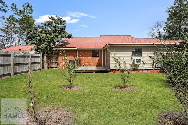 195 Linden Dr, Jesup, GA 31545 - rear view of property with a deck, fence, brick siding, metal roof, and a lawn