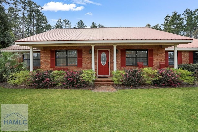 195 Linden Dr, Jesup, GA 31545 - ranch-style house featuring metal roof, a front yard, and brick siding
