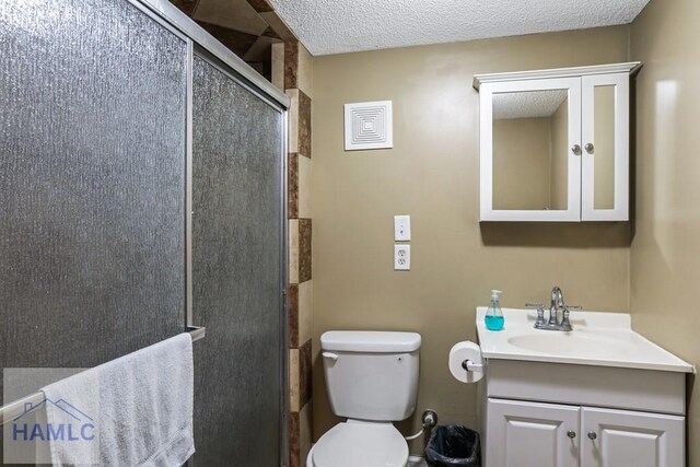 195 Linden Dr, Jesup, GA 31545 - bathroom featuring a textured ceiling, toilet, a stall shower, and vanity