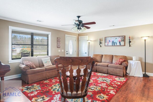 195 Linden Dr, Jesup, GA 31545 - living room with visible vents, crown molding, baseboards, ceiling fan, and wood finished floors