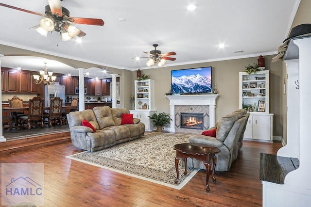 195 Linden Dr, Jesup, GA 31545 - living room with ornate columns, ornamental molding, ceiling fan with notable chandelier, dark wood finished floors, and a fireplace