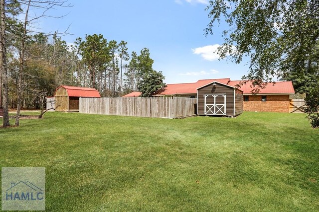 195 Linden Dr, Jesup, GA 31545 - view of yard featuring an outbuilding, fence, and a storage shed