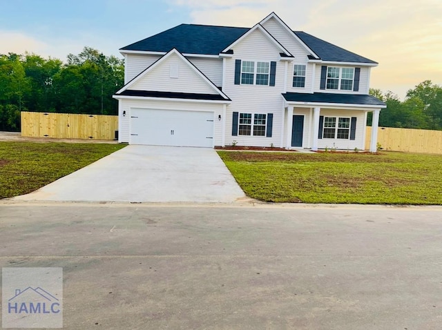 view of front of house with a lawn and a garage