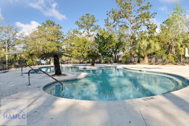 pool featuring fence and a patio