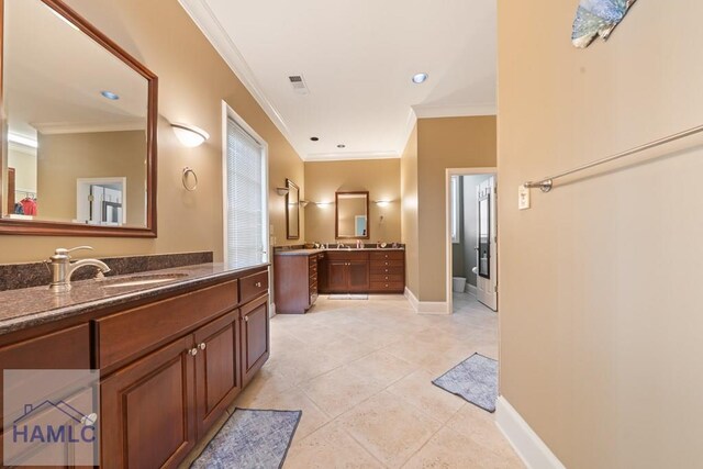 745 Chickasaw Trl, Sparta, GA 31087 - bathroom featuring crown molding, two vanities, baseboards, recessed lighting, and tile patterned flooring