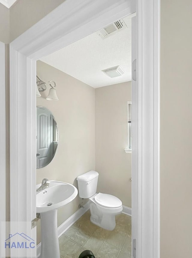 bathroom with tile patterned floors and toilet