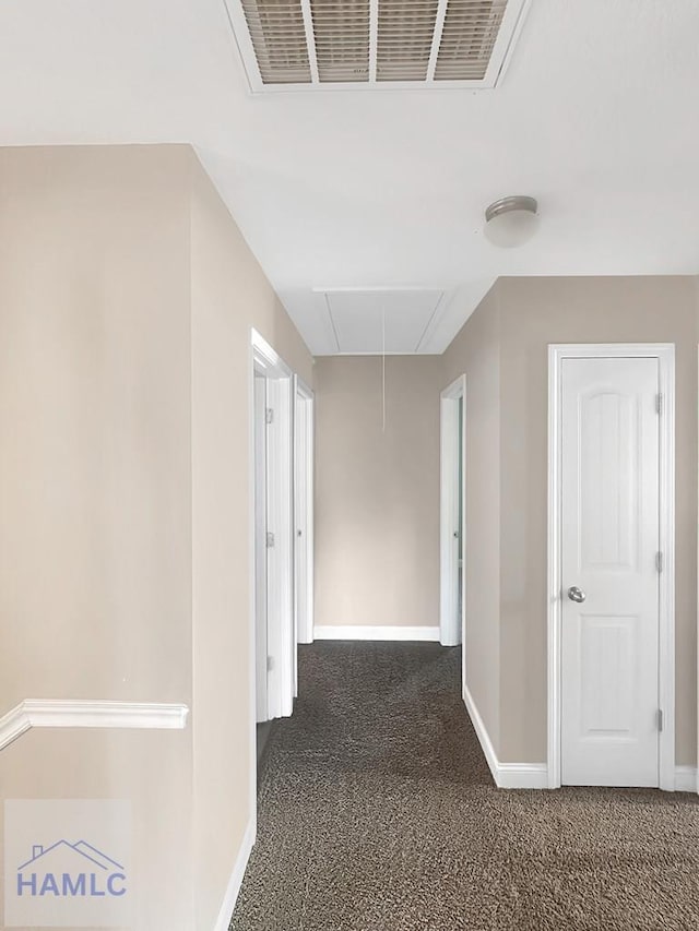 hallway featuring dark carpet