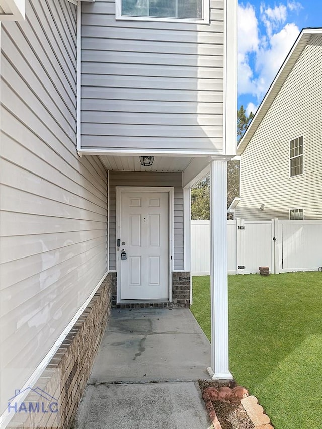 entrance to property with a yard