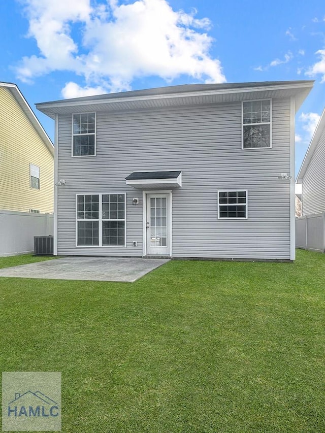 back of house featuring central AC, a patio area, and a lawn