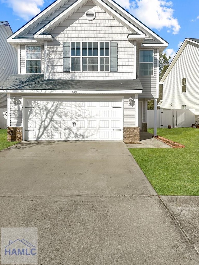 front of property with a garage and a front lawn