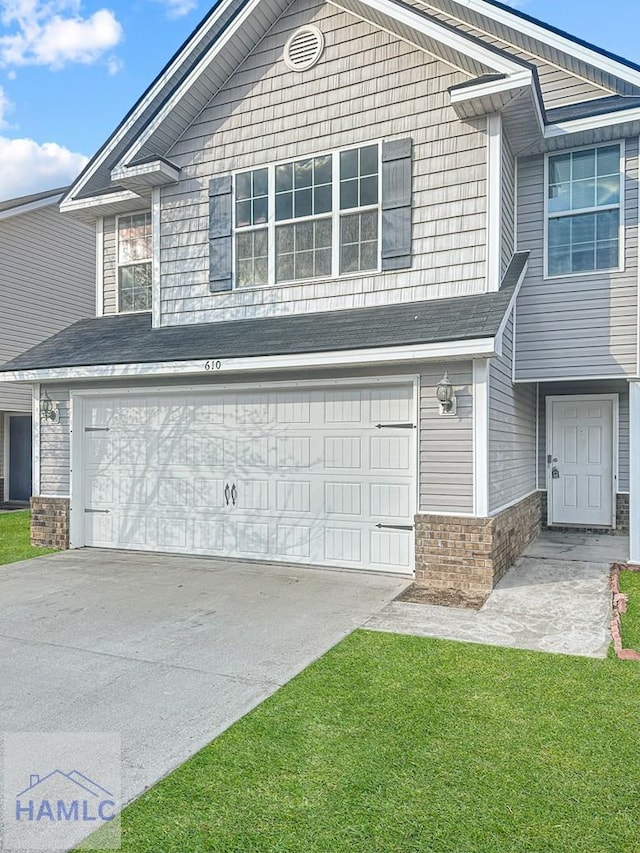 view of front of home featuring a garage and a front lawn