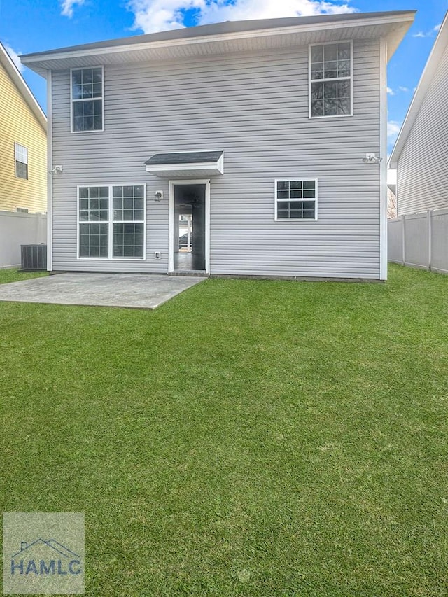 rear view of property with a yard, a patio area, and central air condition unit