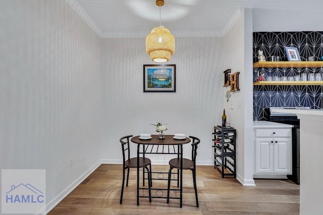 dining room featuring ornamental molding and hardwood / wood-style floors