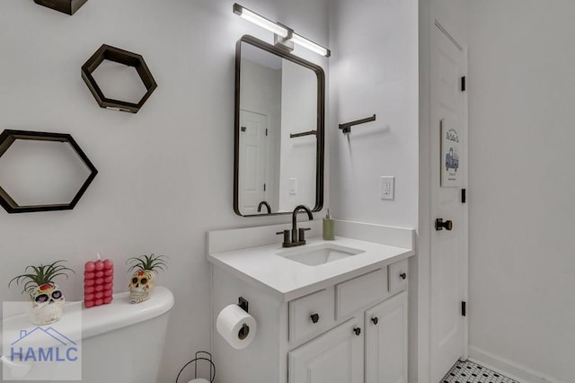 bathroom featuring vanity and toilet