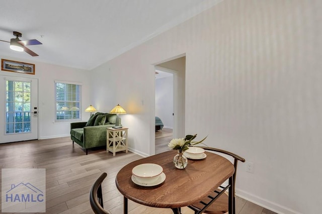 living area with hardwood / wood-style flooring and ceiling fan