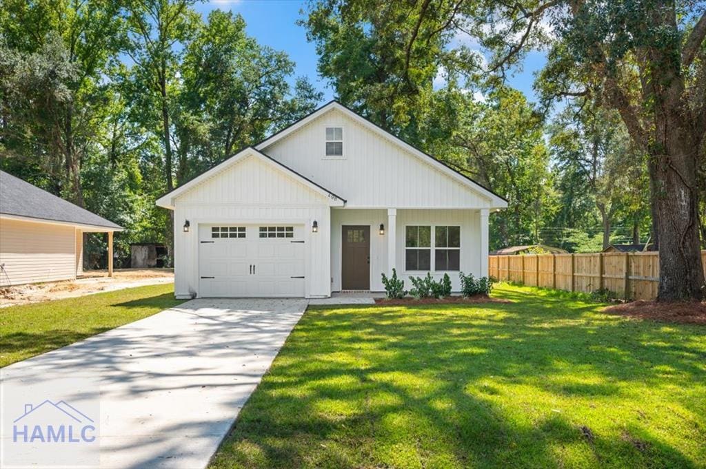 modern farmhouse style home featuring a garage and a front lawn