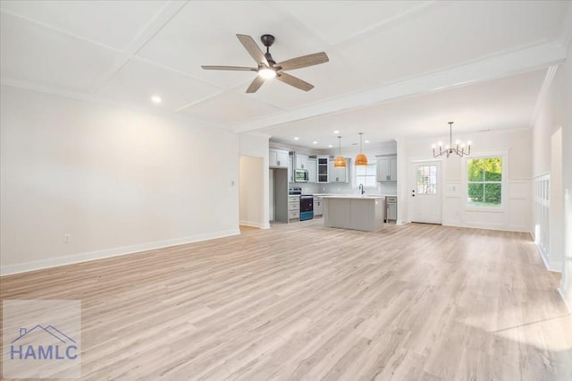 unfurnished living room featuring light wood-type flooring, ceiling fan with notable chandelier, and ornamental molding