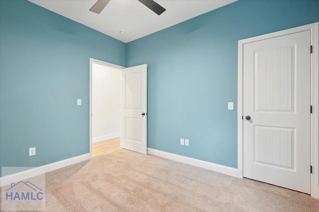 unfurnished bedroom featuring light colored carpet and ceiling fan