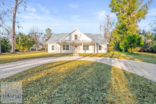 view of front of property with covered porch and a front yard