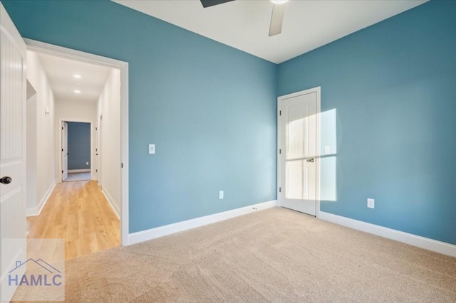 carpeted empty room featuring ceiling fan