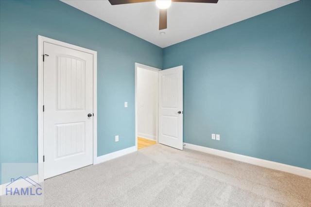 unfurnished bedroom with ceiling fan and light carpet