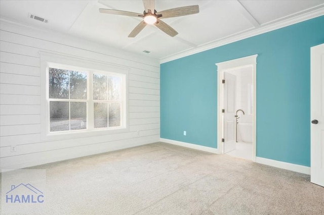 empty room featuring ceiling fan, ornamental molding, and carpet floors