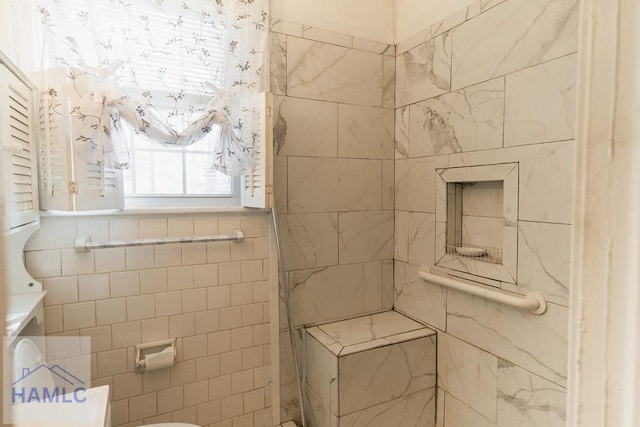 full bathroom featuring tiled shower, tile walls, and toilet