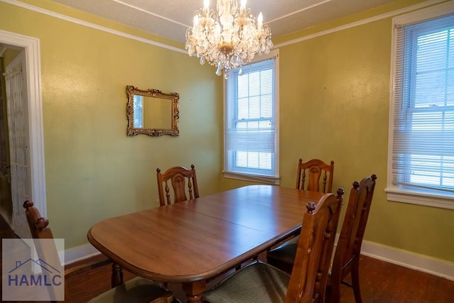 dining area with ornamental molding, plenty of natural light, and wood finished floors