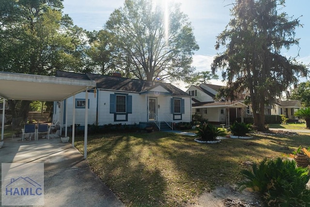 view of front facade with a carport and a front yard