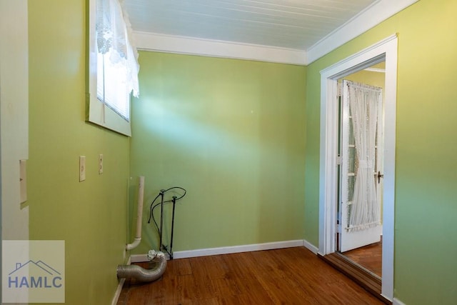 clothes washing area featuring wood finished floors and baseboards